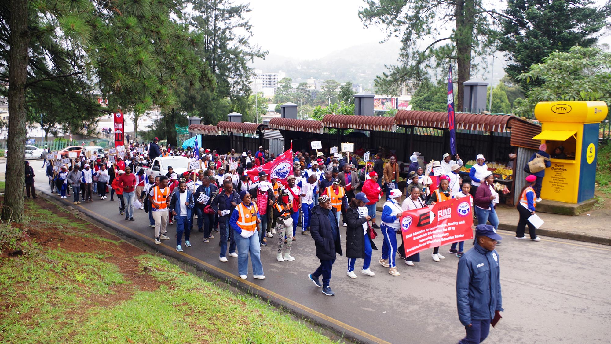 A group of teachers under the SNAT banner marching the inter-ministerial building.